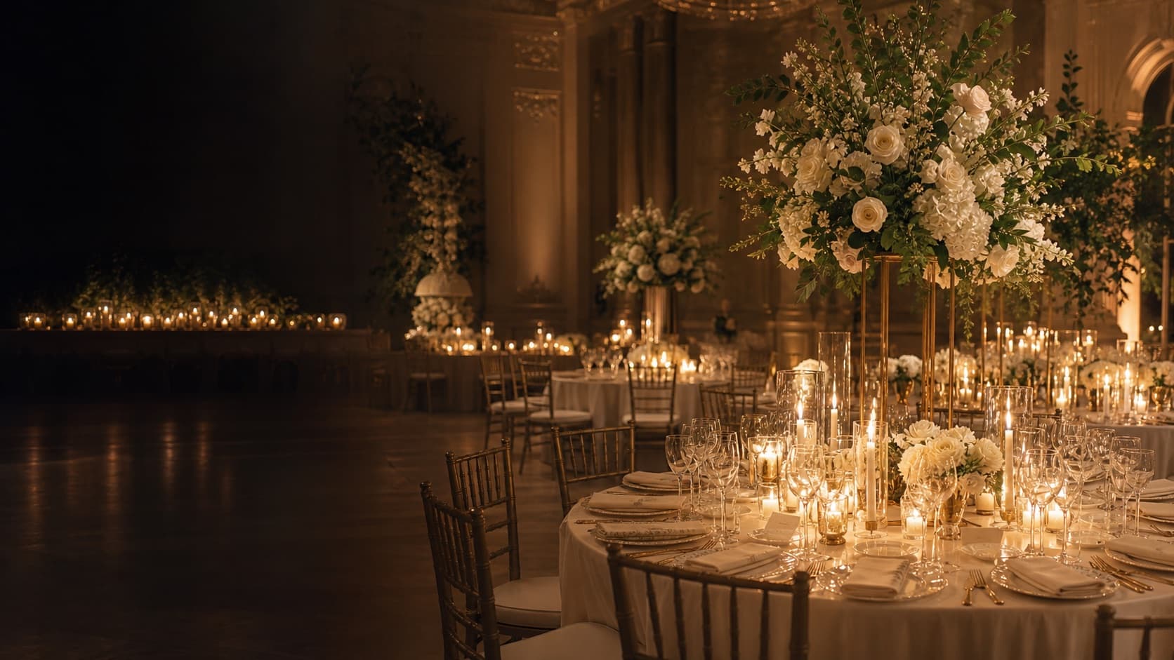 Luxury candlelit wedding reception with ivory florals and champagne accents